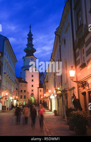 Saint Michaels Tower illuminated at night, Bratislava, Slovakia. Built in the 13th century, it remains the only Gothic gateway remaining along the Old City walls. Stock Photo