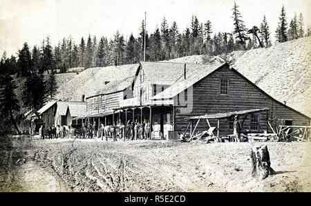 Description: Depicts the Colonial Hotel with people posed in front ...