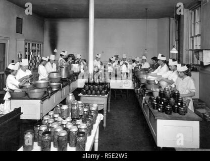 High School girls set the pace for their elders by conducting community canning centers. Taken in Lewis and Clark High School Spokane, WA ca. 1914-1919 Stock Photo