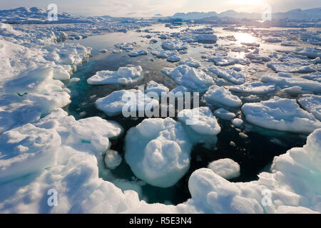 Tiniteqilaq and sea ice in fjord, E. Greenland Stock Photo