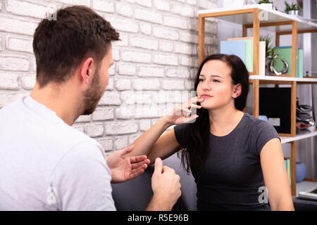 Close-up Of Man Talking With Young Woman At Home Stock Photo