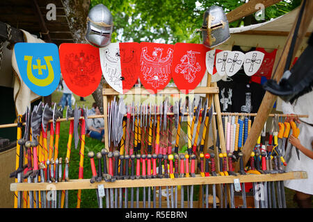 TRAKAI, LITHUANIA - JUNE 16, 2018: Toy medieval armour, helmets and wooden weapons sold on market stall during annual Medieval Festival, held in Traka Stock Photo