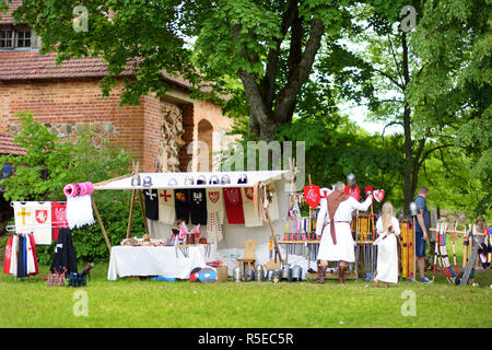 TRAKAI, LITHUANIA - JUNE 16, 2018: Toy medieval armour, helmets and wooden weapons sold on market stall during annual Medieval Festival, held in Traka Stock Photo