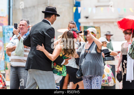 BUENOS AIRES, ARGENTINA - DECEMBER 25, 2017: Couple dancing tango on city street. With selective focus Stock Photo
