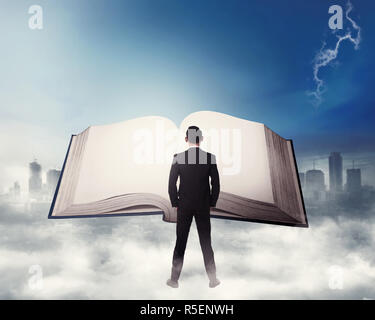 Young business man reading big book Stock Photo