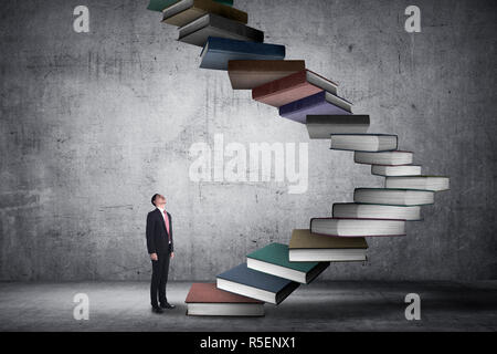 Business person step up flying book that look like stair Stock Photo