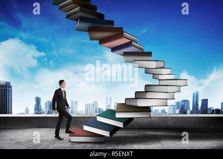 Business person step up flying book that look like stair Stock Photo