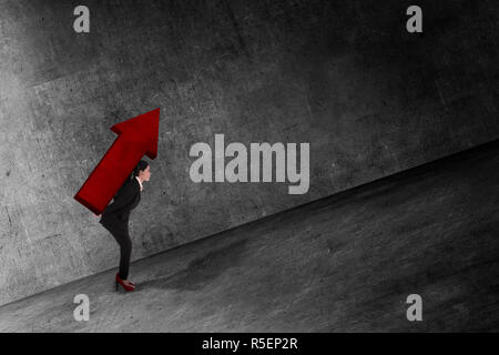 Asian business woman carry big red arrow on her back Stock Photo - Alamy