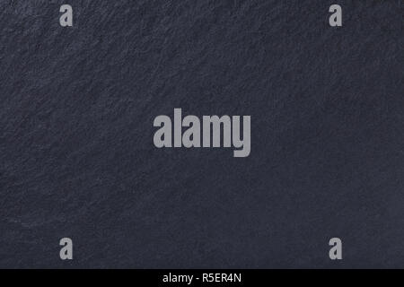 Dark gray background of natural slate. Texture black stone close up. Graphite backdrop macro Stock Photo