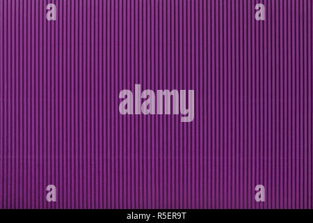 Texture of corrugated dark purple paper, macro. Striped pattern of violet cardboard background, closeup. Stock Photo