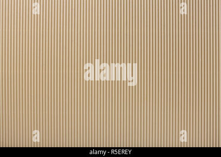 Texture of corrugated light beige paper, macro. Striped pattern of brown cardboard background, closeup. Stock Photo