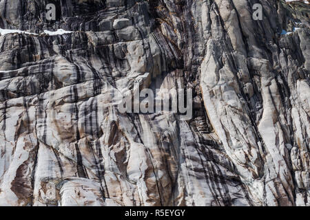 Eroded cracked granite cliff in multiple gray shades Stock Photo