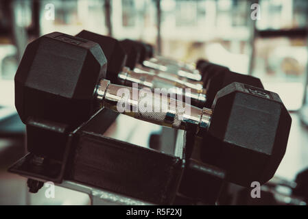 dumbbells in the gym at sports club for exercise and Bodybuilding Stock Photo