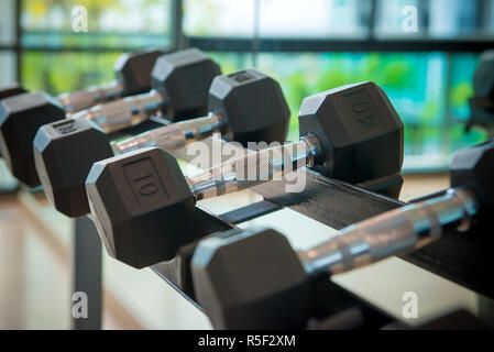 dumbbells in the gym at sports club for exercise and Bodybuilding Stock Photo