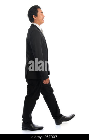 Side view Asian businessman walking Stock Photo