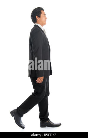 Side view Asian business man walking Stock Photo