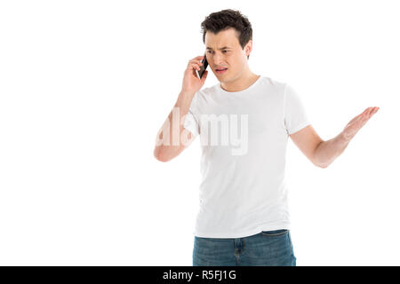 confused handsome man talking on smartphone isolated on white Stock Photo