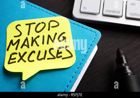 Stop making excuses written on a piece of paper. Stock Photo