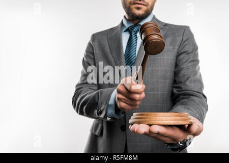 low angle view of judge holding wooden hammer isolated on white Stock Photo