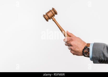 close-up partial view of male judge holding wooden hammer isolated on white Stock Photo