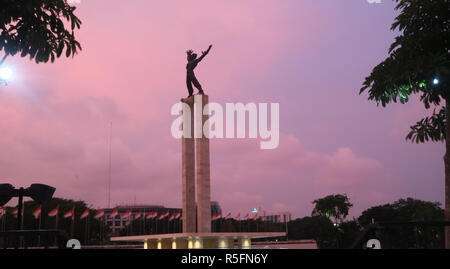 a freedom statue at west irian liberation monument in sunset moment Stock Photo