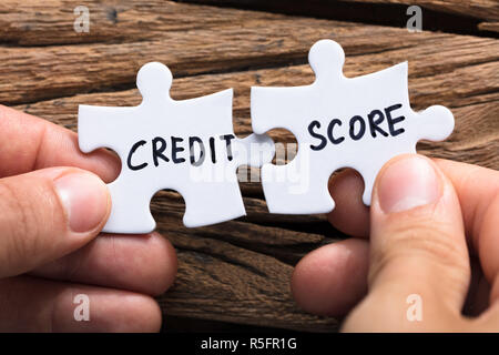 Hands Connecting Credit Score Jigsaw Pieces Stock Photo