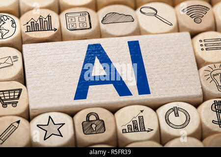 AI Text On Wooden Block Surrounded By Computer Icons Stock Photo