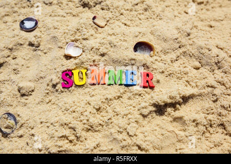 Inscription summer on sand with seashells Stock Photo