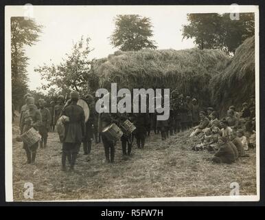 Indian Infantry Band [40th Pathans] playing to a group of French peasants on a French farm [at St Floris, France], 23rd July 1915. Record of the Indian Army in Europe during the First World War. 20th century, 23rd July 1915. Gelatin silver prints. Source: Photo 24/(45). Author: Girdwood, H. D. Stock Photo