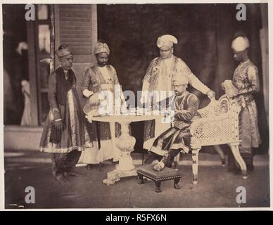 H.E. the Tondiman Rajah with his Ministers. [Pudukkottai]. A group with Ramchandra Tondiman, Raja of Pudukkottai, seated at a table in the act of signing a document, with four ministers standing around him. Linnaeus Tripe, 'Photographic Views of Poodoocottah' (Madras, 1858). 1858. Albumen print, 220 x 170 mm. Source: Photo 952/(3). Stock Photo