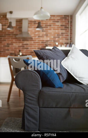 Gray sofa with pillows close up in aparment room Stock Photo