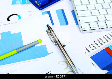 Financial chart paper, pen and pencil. Stock Photo