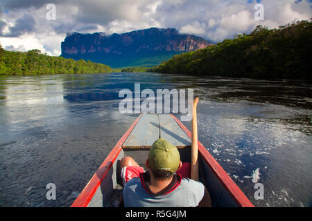 Venezuela, Guayana, Canaima National Park,  Boat trip to Angel Falls, Pemon man in boat Stock Photo