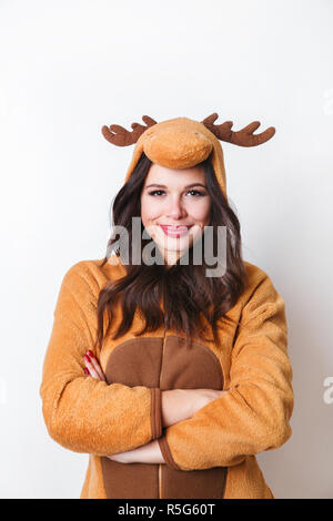 Kigurumi pajamas. Close-up portrait of funny cute young woman in pajamas looking in kamera on white background Stock Photo