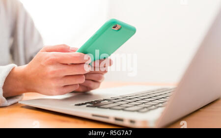 Using cellphone and laptop computer Stock Photo