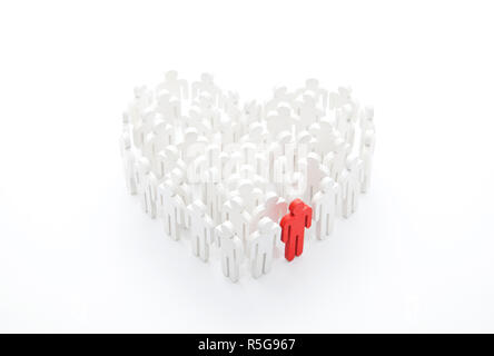 Group of people in the shape of a heart with one red person Stock Photo