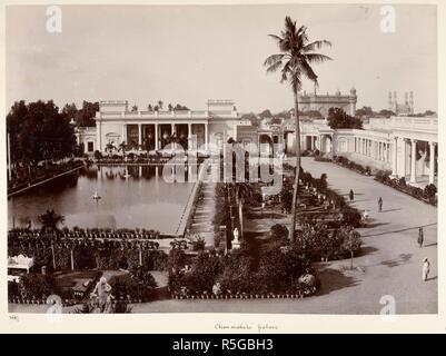 Chow-mahela palace [Hyderabad]. A view looking across the garden and tank towards one of the buildings of the Chaumahalla Palace, with the Char Minar in the right background. Curzon Collection: 'Souvenir of the Visit of H.E. Lord Curzon of Kedleston Viceroy of India to H.H. the Nizam's Dominions April 1902'. c. 1902. Photograph. Source: Photo 430/33(41). Language: English. Author: Dayal, Deen. Stock Photo