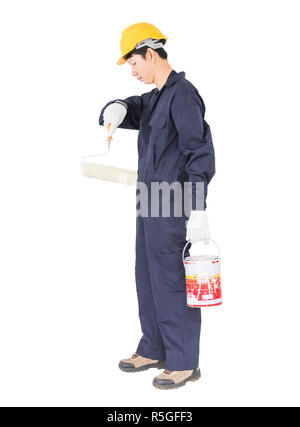 Worker in uniform using paint roller is painting invisible wall Stock Photo