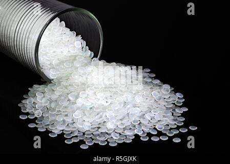 Industrial white plastic beads, granules on black background. Stock Photo