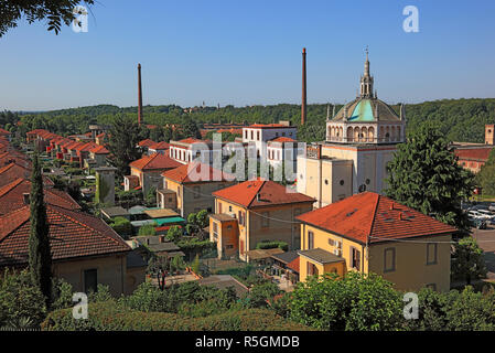 View of the Crespi d&#39;Adda village, church and part of the former textile factory, industrial monument, Lombardy, Italy Stock Photo