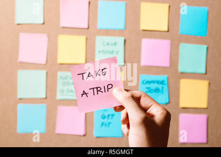 Motivational word 'Take a trip' on pink card Stock Photo