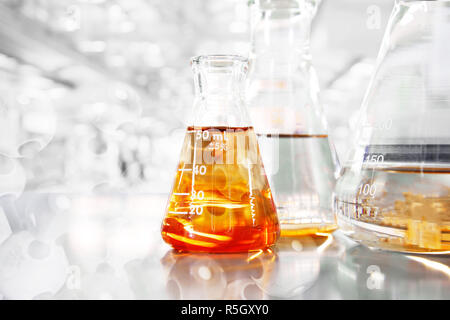 orange so in conical three flasks with chemical structure in science education laboratory background Stock Photo