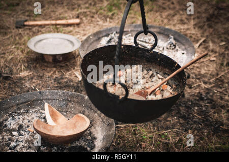 Viking food cooking on a replica historic campfire at Gudvangen Viking market Norway. Stock Photo