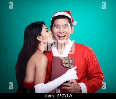 Santa woman give kiss to her lover Stock Photo