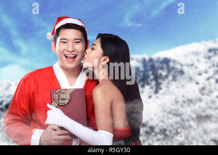 Santa woman give kiss to her lover Stock Photo
