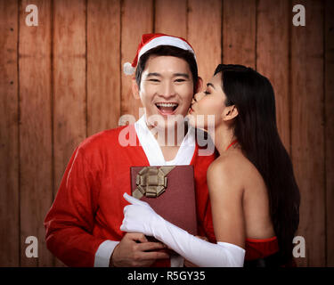 Santa woman give kiss to her lover Stock Photo