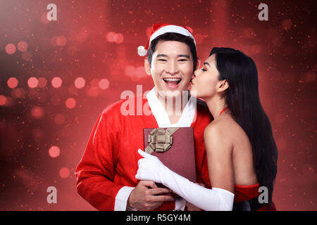 Santa woman give kiss to her lover Stock Photo