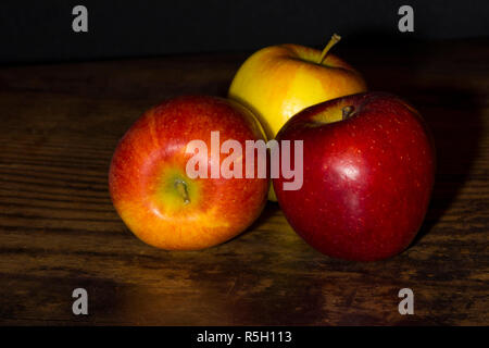 Close up of braeburn apples on a dark wooden board Stock Photo
