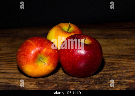 Close up of braeburn apples on a dark wooden board Stock Photo