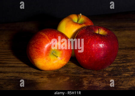 Close up of braeburn apples on a dark wooden board Stock Photo